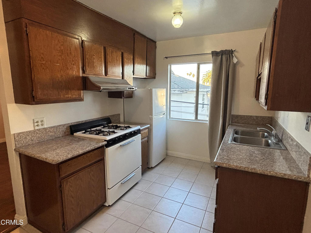 124 South Olive Avenue, Unit B Alhambra, CA 91801 - Photo 5 of 12 a kitchen with a sink stove top oven and cabinets