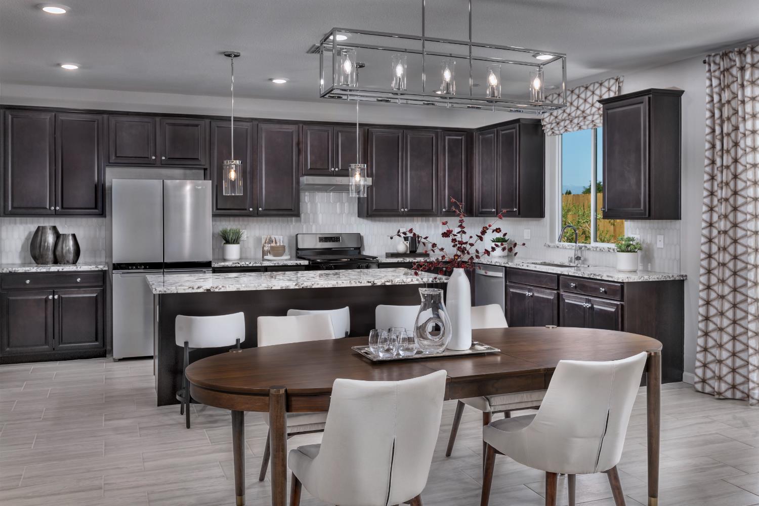 4553 Griffith Avenue Clovis, CA 93619 - Photo 6 of 10 a kitchen with a dining table chairs refrigerator and microwave