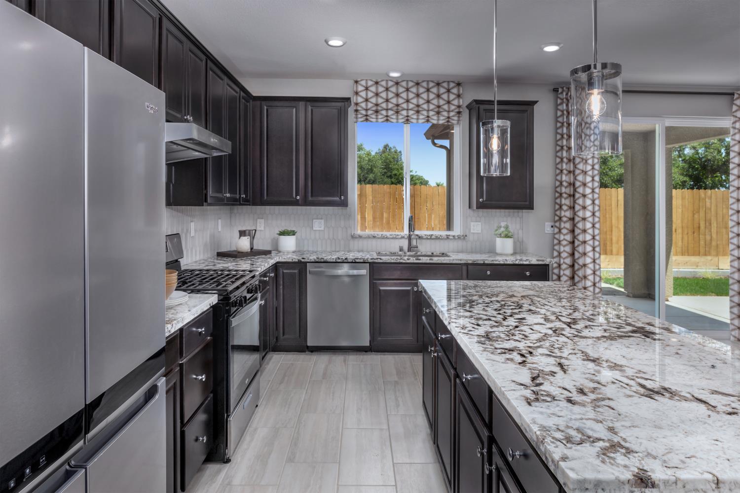 4553 Griffith Avenue Clovis, CA 93619 - Photo 8 of 10 a kitchen with a stove sink and a refrigerator