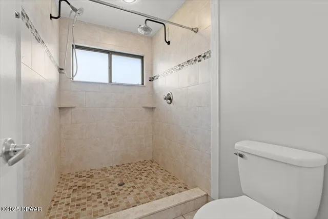 a bathroom with a shower and a toilet