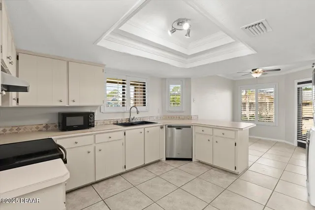 a kitchen with white cabinets a sink and appliances