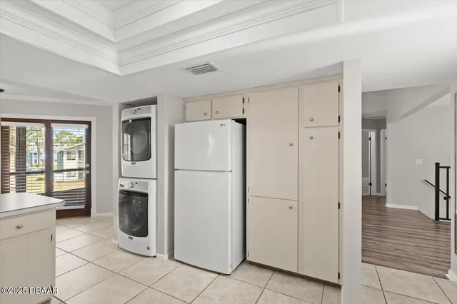 a white refrigerator freezer and a stove sitting inside of a kitchen