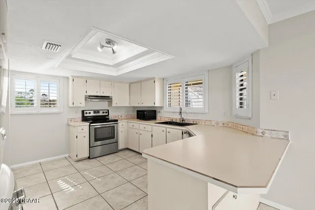 a kitchen with appliances a sink and cabinets