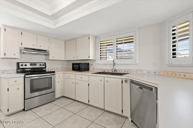 a kitchen with cabinets appliances and a window