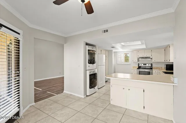 a kitchen with white cabinets and white appliances