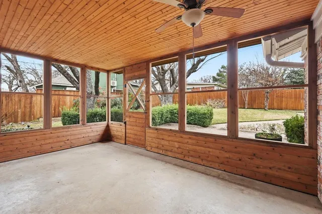 an empty room with large windows