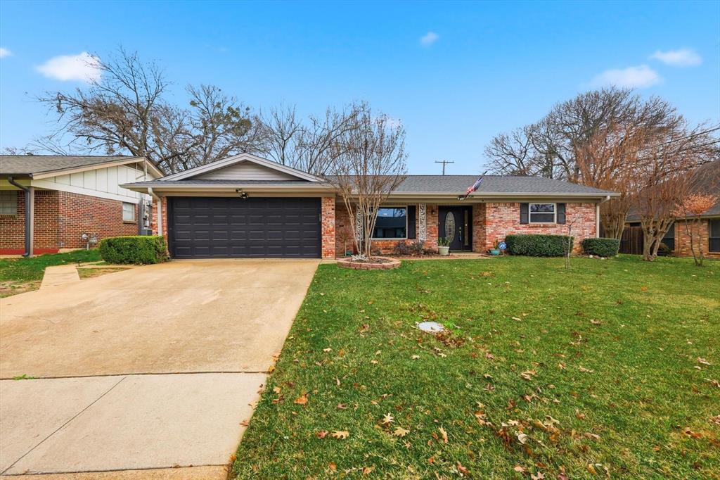 324 Moore Creek Road Hurst, TX 76053 - Photo 2 of 22 a front view of house with yard and green space