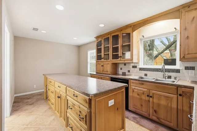 a kitchen that has a sink and a stove in it