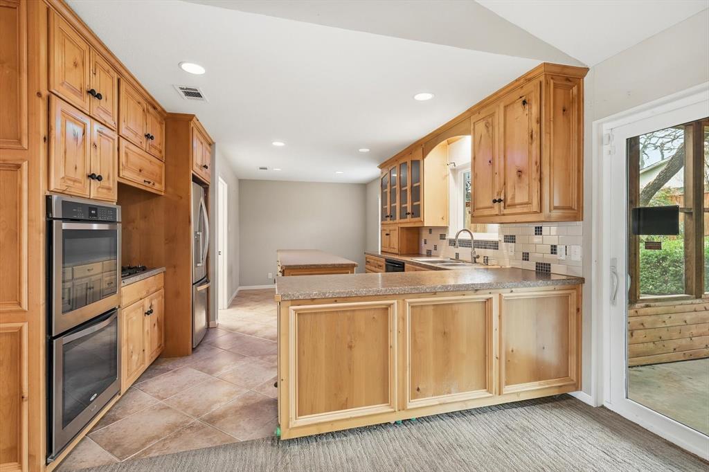 324 Moore Creek Road Hurst, TX 76053 - Photo 10 of 22 a kitchen with stainless steel appliances granite countertop a stove a sink and a refrigerator