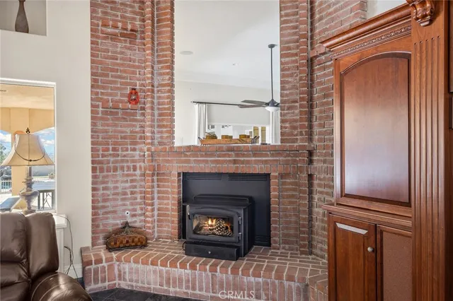 a dining room with furniture a chandelier and wooden floor