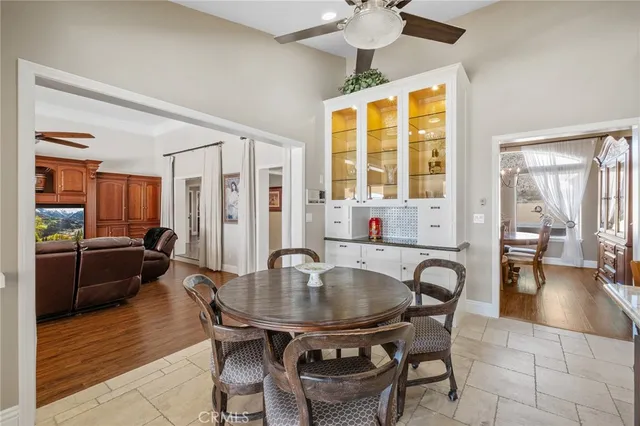 a kitchen with stainless steel appliances kitchen island granite countertop a kitchen island a stove a table and chairs in it