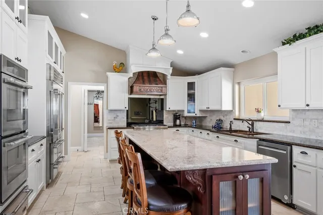a kitchen with stainless steel appliances granite countertop a stove and a sink