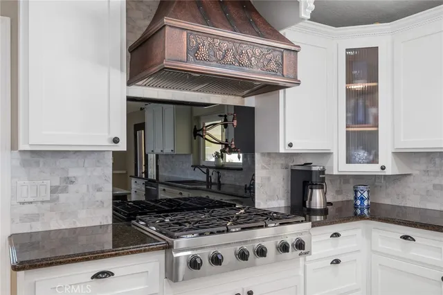 a kitchen with stainless steel appliances a stove sink and cabinets