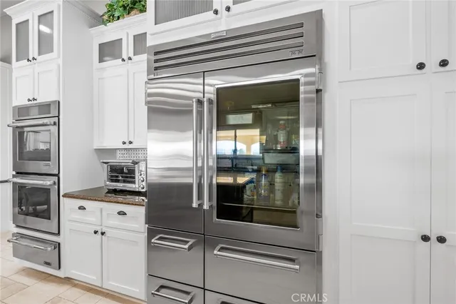 a view of a livingroom with workspace and a window