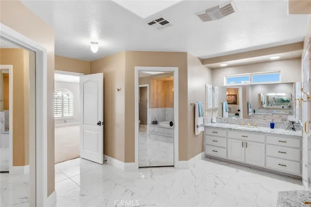 a kitchen with stainless steel appliances granite countertop a refrigerator a stove and a sink