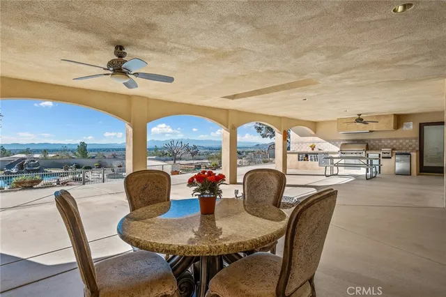 a view of a terrace with lawn chairs