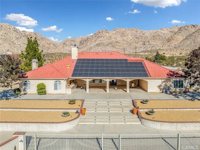 a view of a swimming pool with a yard and sitting area