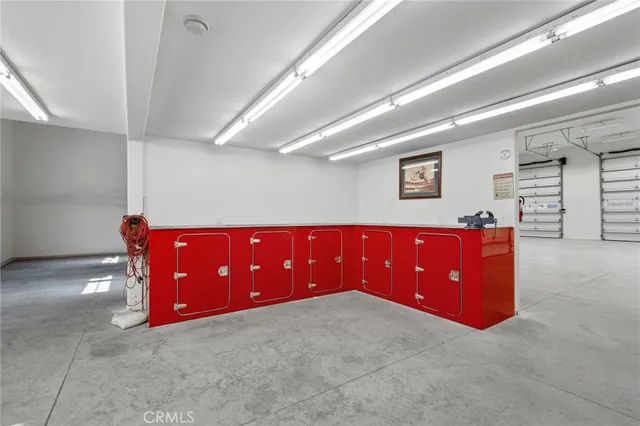 a view of kitchen with stainless steel appliances granite countertop wooden cabinets a refrigerator and a sink