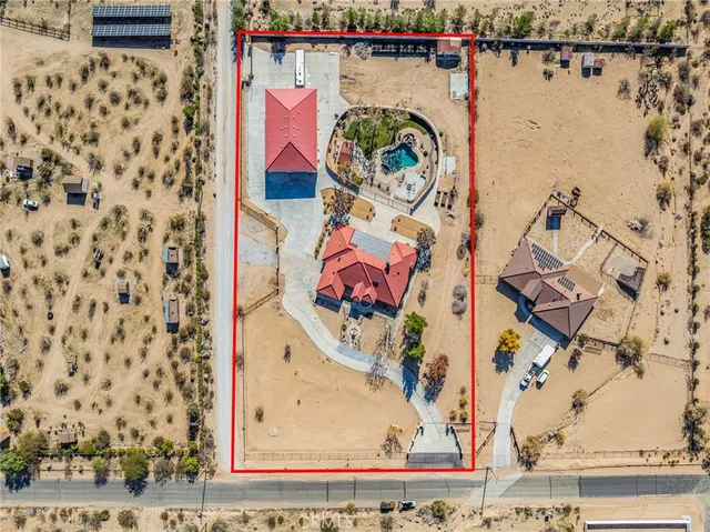 a roof deck with table and chairs under an umbrella