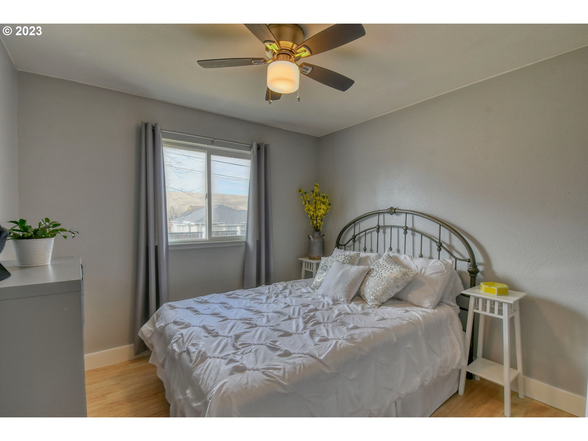 1320 Southwest 37th Street Pendleton, OR 97801 - Photo 21 of 31 a bedroom with a bed and a chandelier