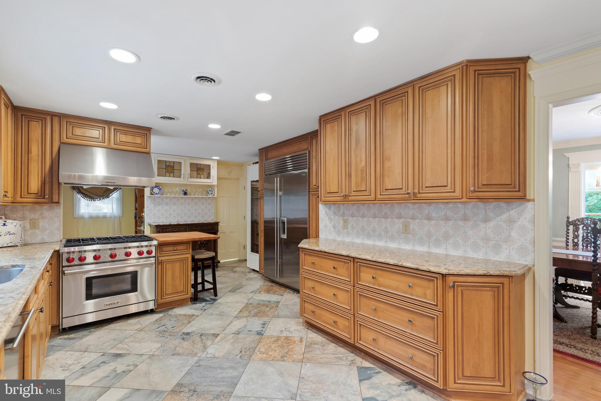 8751 Brook Road McLean, VA 22102 - Photo 21 of 103 a kitchen with stainless steel appliances granite countertop a stove and a refrigerator
