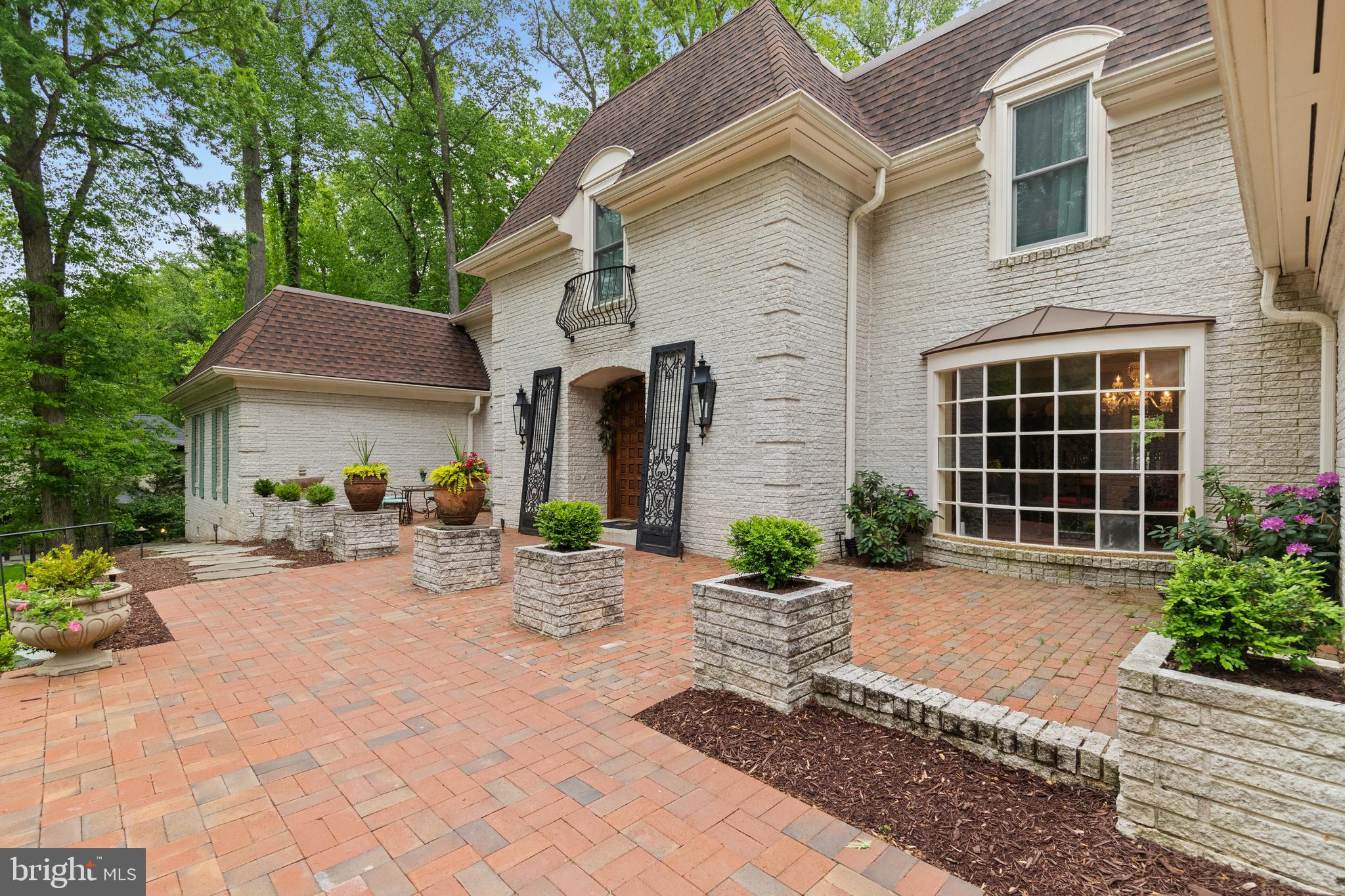 8751 Brook Road McLean, VA 22102 - Photo 77 of 103 a front view of a house with garden and plants
