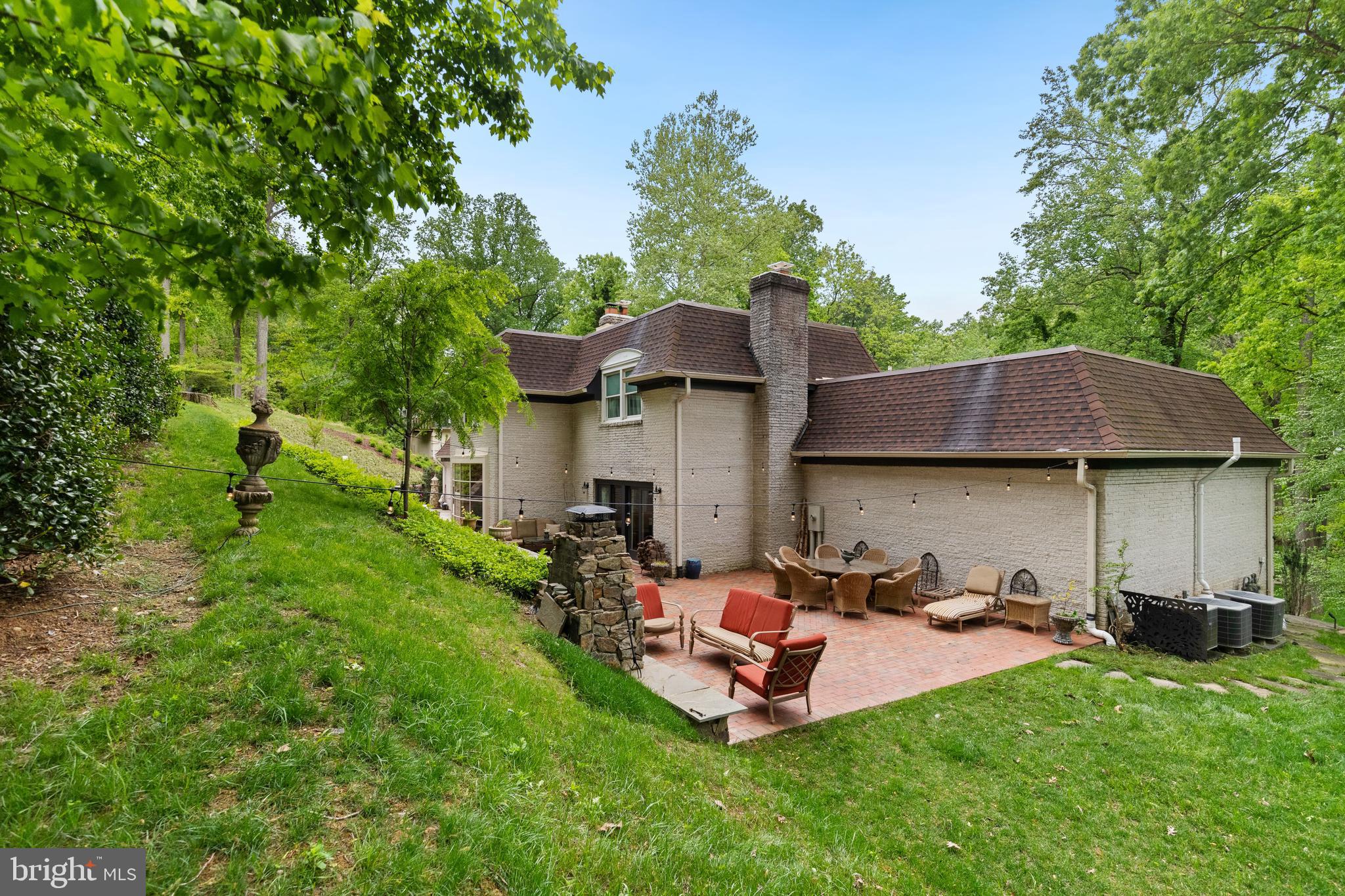 8751 Brook Road McLean, VA 22102 - Photo 80 of 103 a view of a backyard with table and chairs under an umbrella