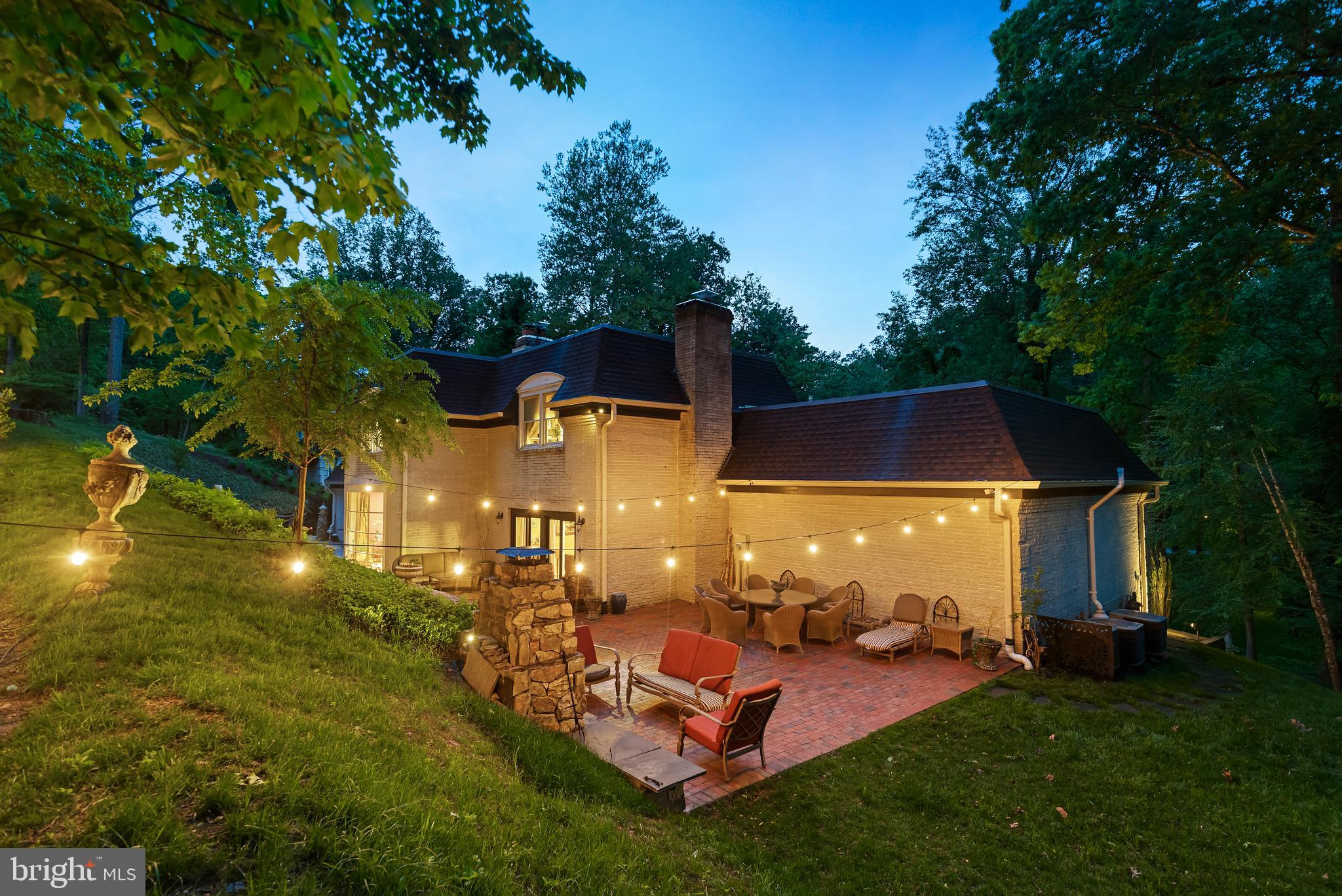 8751 Brook Road McLean, VA 22102 - Photo 85 of 103 a view of a patio with table and chairs with wooden fence and plants