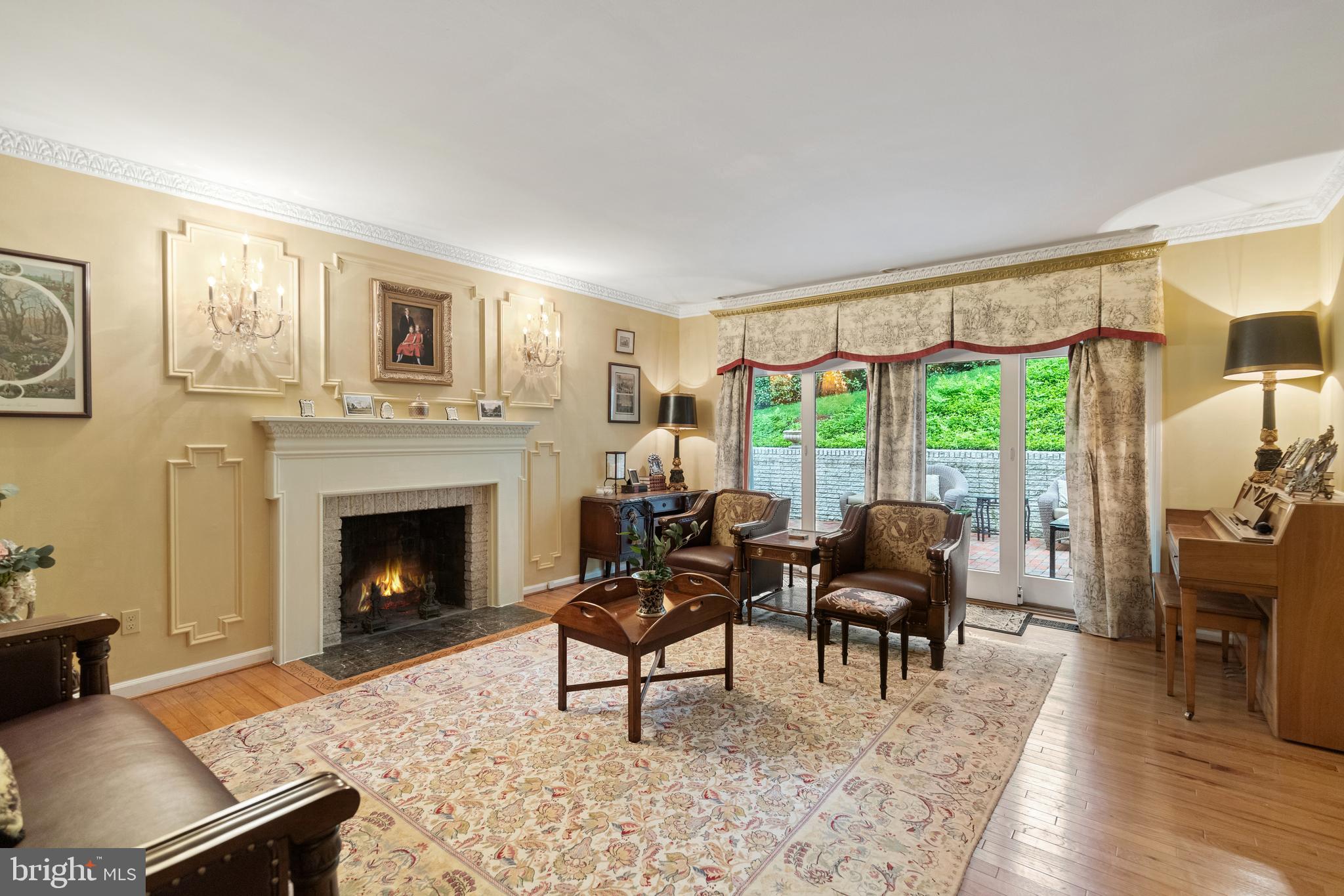 8751 Brook Road McLean, VA 22102 - Photo 9 of 103 a living room with furniture a fireplace and large windows