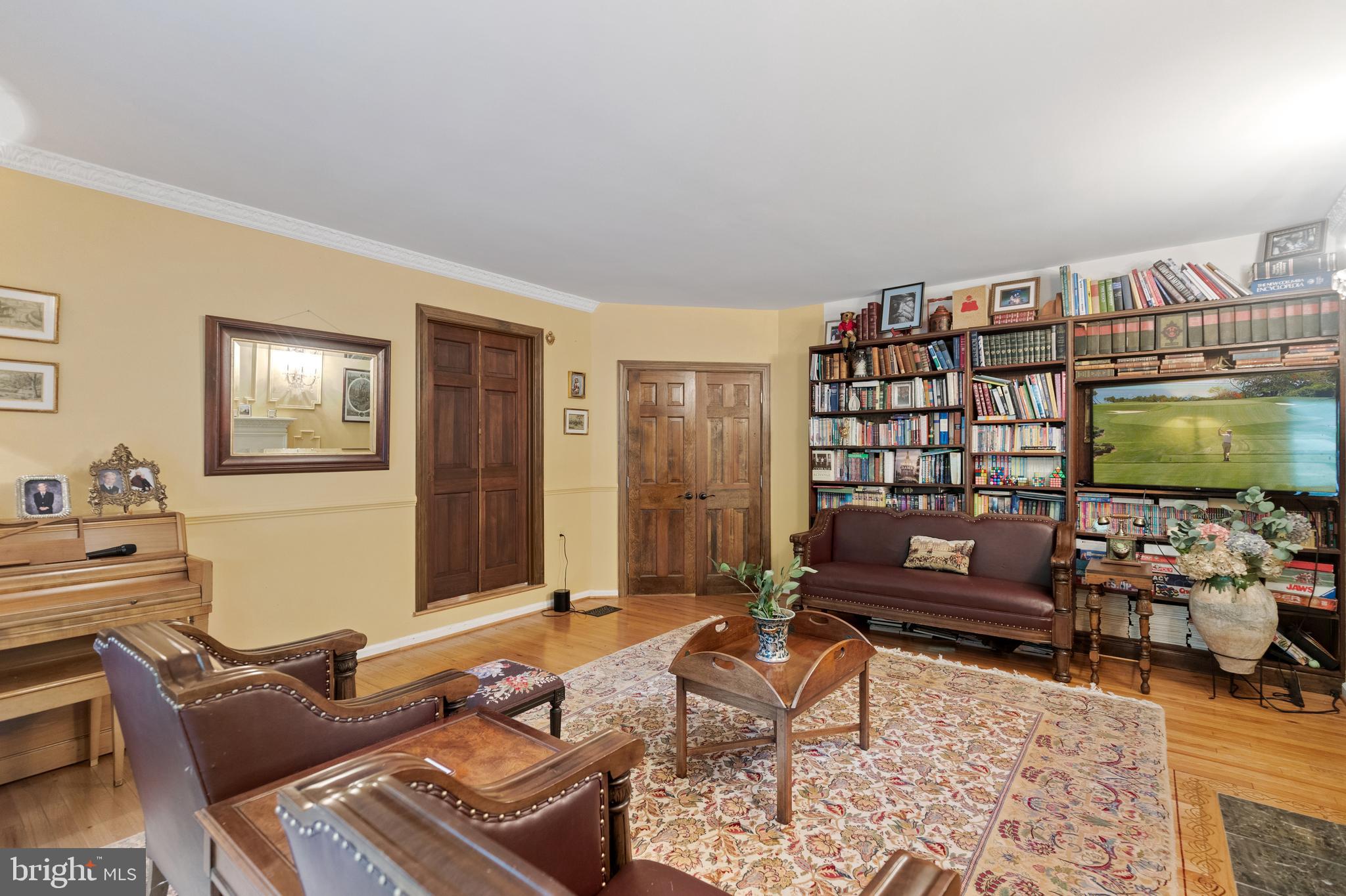 8751 Brook Road McLean, VA 22102 - Photo 10 of 103 a living room with furniture a rug and a flat screen tv