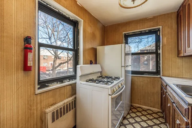 a kitchen with stainless steel appliances a stove a refrigerator and a microwave