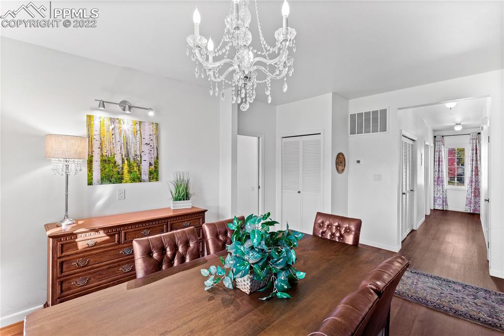3105 Broadmoor Valley Road, Unit D Colorado Springs, CO 80906 - Photo 11 of 27 a living room with furniture and a chandelier