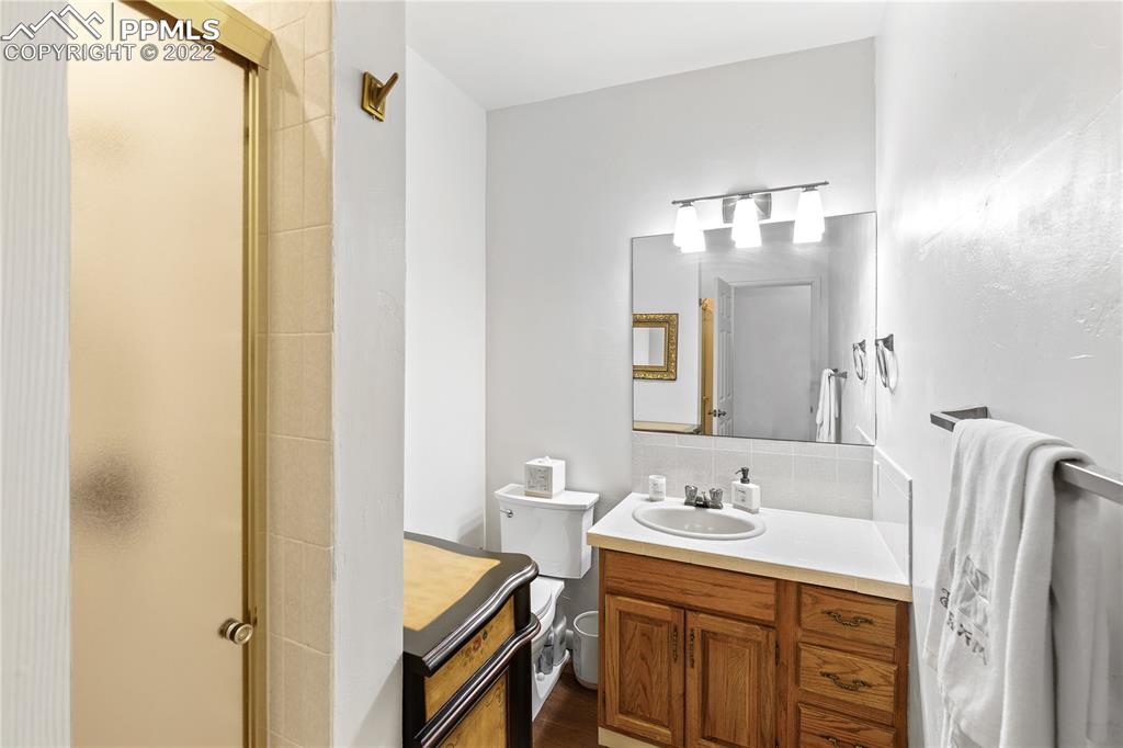3105 Broadmoor Valley Road, Unit D Colorado Springs, CO 80906 - Photo 20 of 27 a bathroom with a double vanity sink and mirror