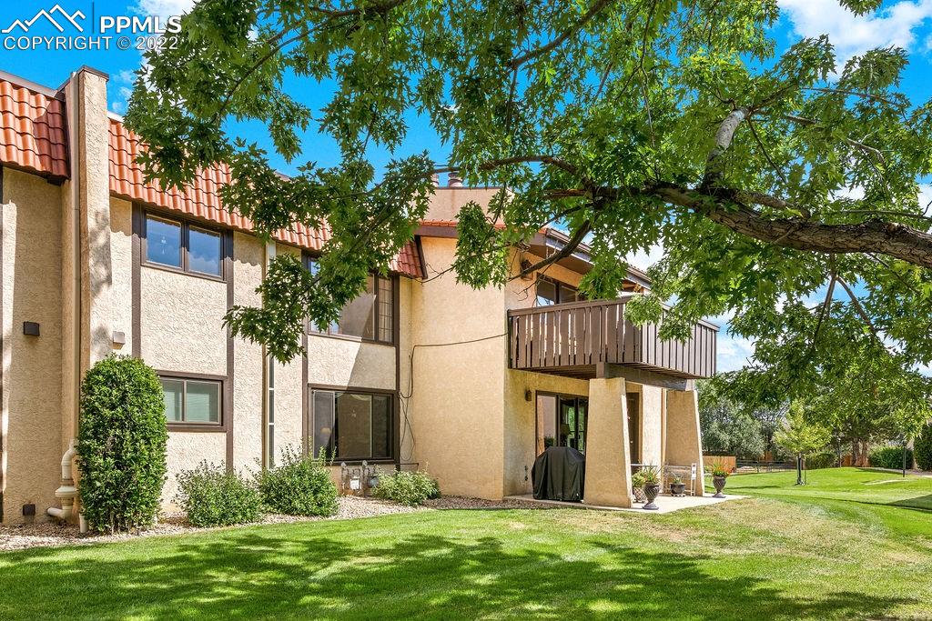 3105 Broadmoor Valley Road, Unit D Colorado Springs, CO 80906 - Photo 2 of 27 a front view of a house with a garden