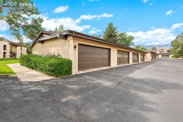 a view of a house with a yard and garage