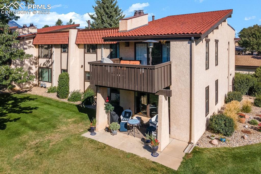 3105 Broadmoor Valley Road, Unit D Colorado Springs, CO 80906 - Photo 23 of 27 a view of a small house with yard and furniture