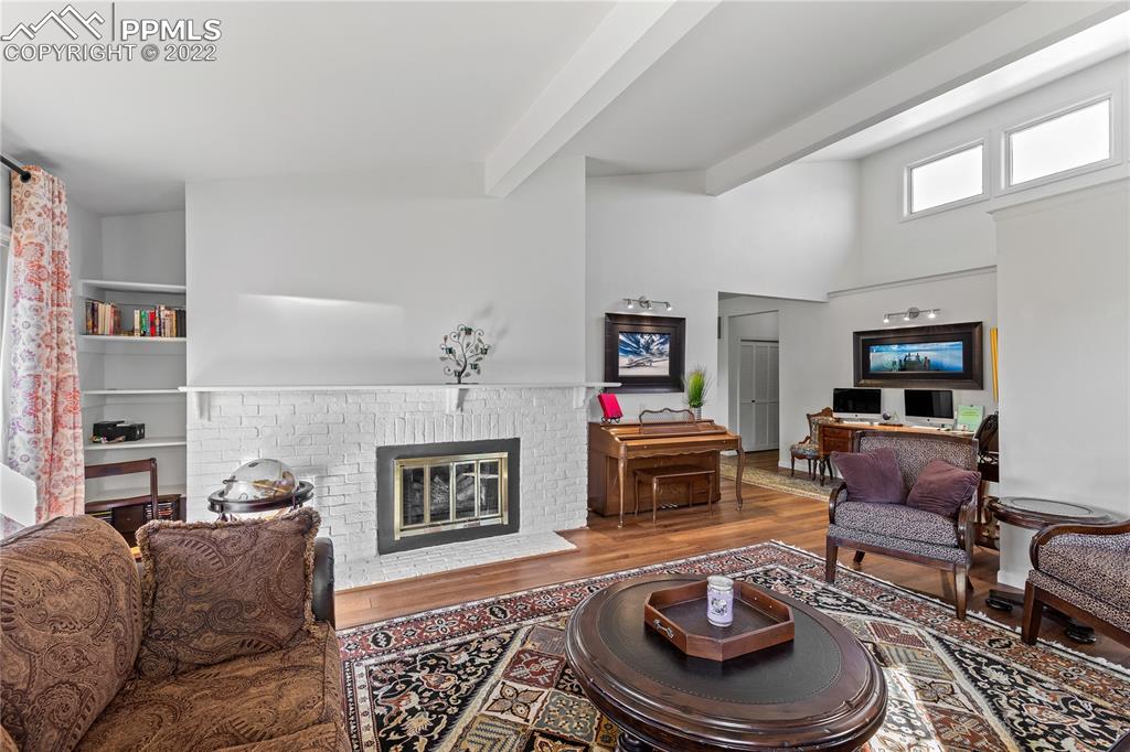 3105 Broadmoor Valley Road, Unit D Colorado Springs, CO 80906 - Photo 4 of 27 a living room with furniture a fireplace and a flat screen tv