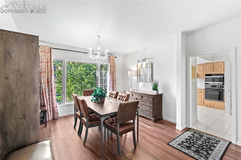 3105 Broadmoor Valley Road, Unit D Colorado Springs, CO 80906 - Photo 5 of 27 a view of a dining room with furniture window and wooden floor