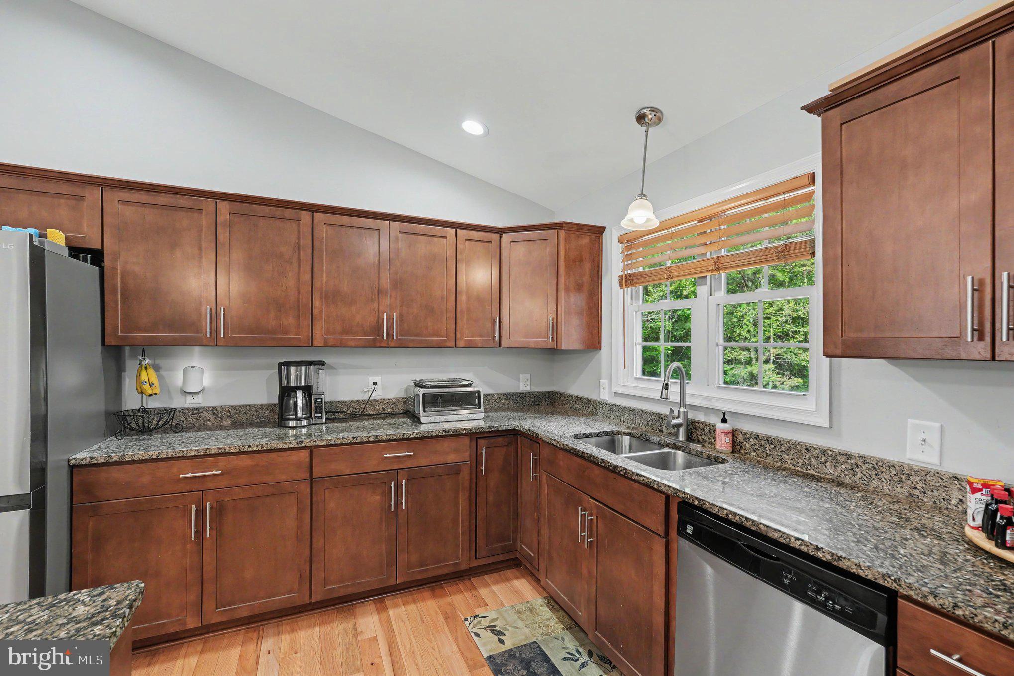 8474 Timothy Lane Rixeyville, VA 22737 - Photo 11 of 49 a kitchen with a sink a window and cabinets