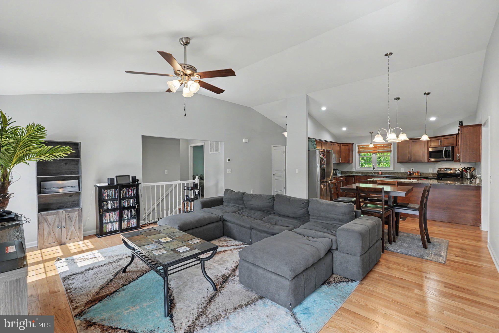 8474 Timothy Lane Rixeyville, VA 22737 - Photo 7 of 49 a living room with furniture kitchen view and a wooden floor