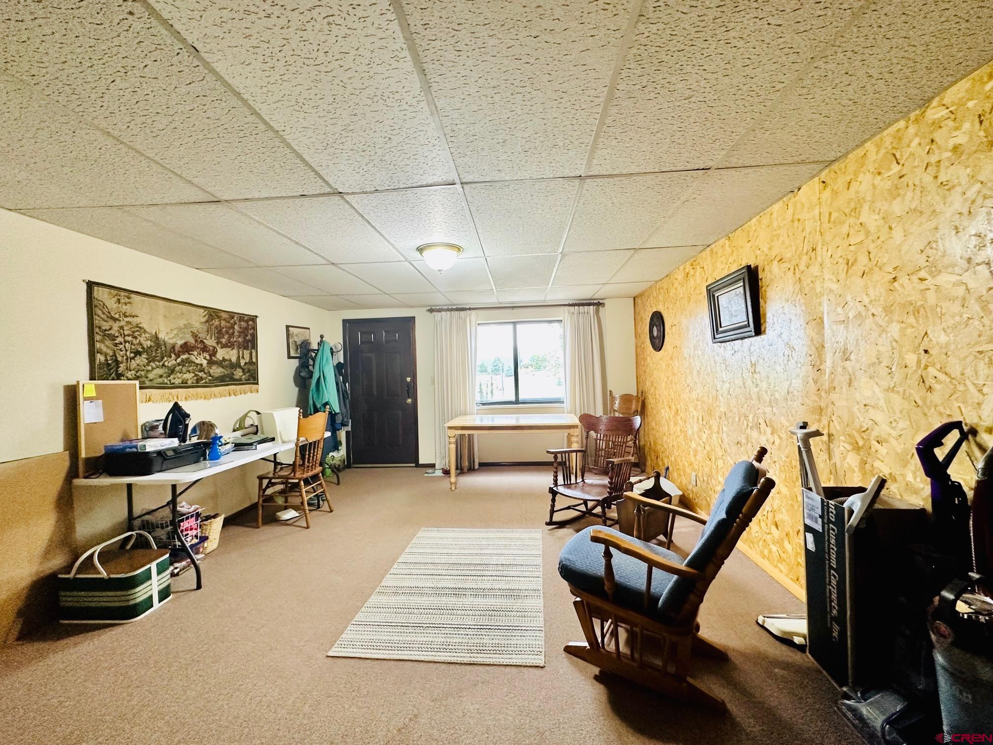 18574 Eastridge Road Cedaredge, CO 81413 - Photo 20 of 20 a living room with furniture gym equipment and a window