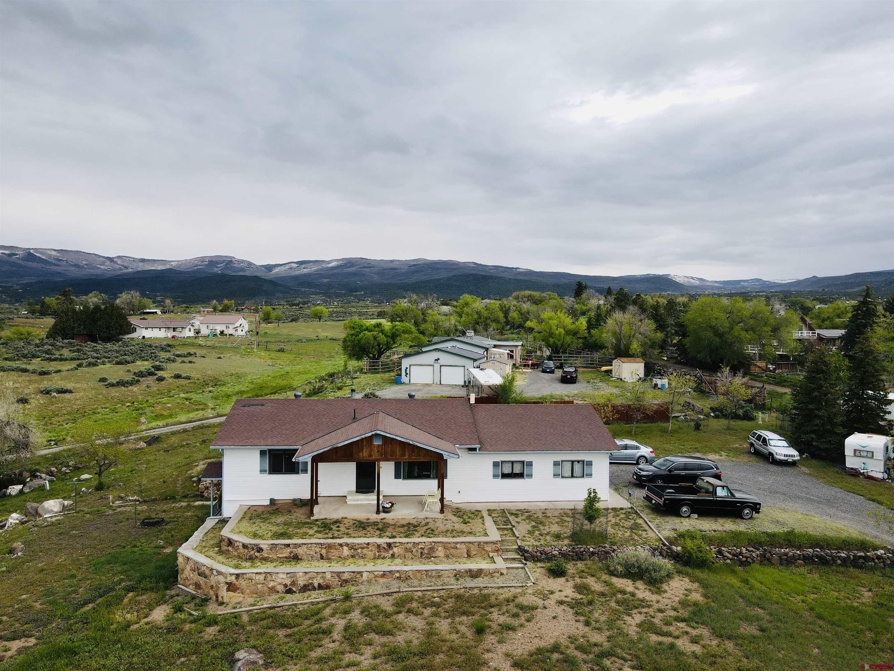18574 Eastridge Road Cedaredge, CO 81413 - Photo 2 of 20 a aerial view of a house with garden space and outdoor seating