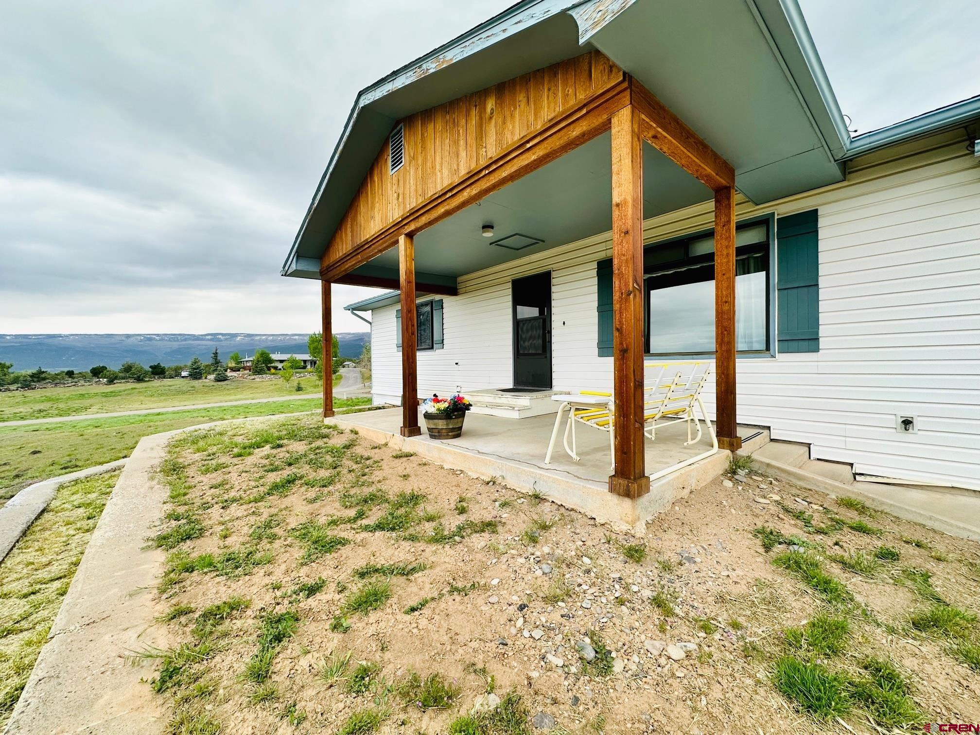 18574 Eastridge Road Cedaredge, CO 81413 - Photo 4 of 20 a view of a house with a yard