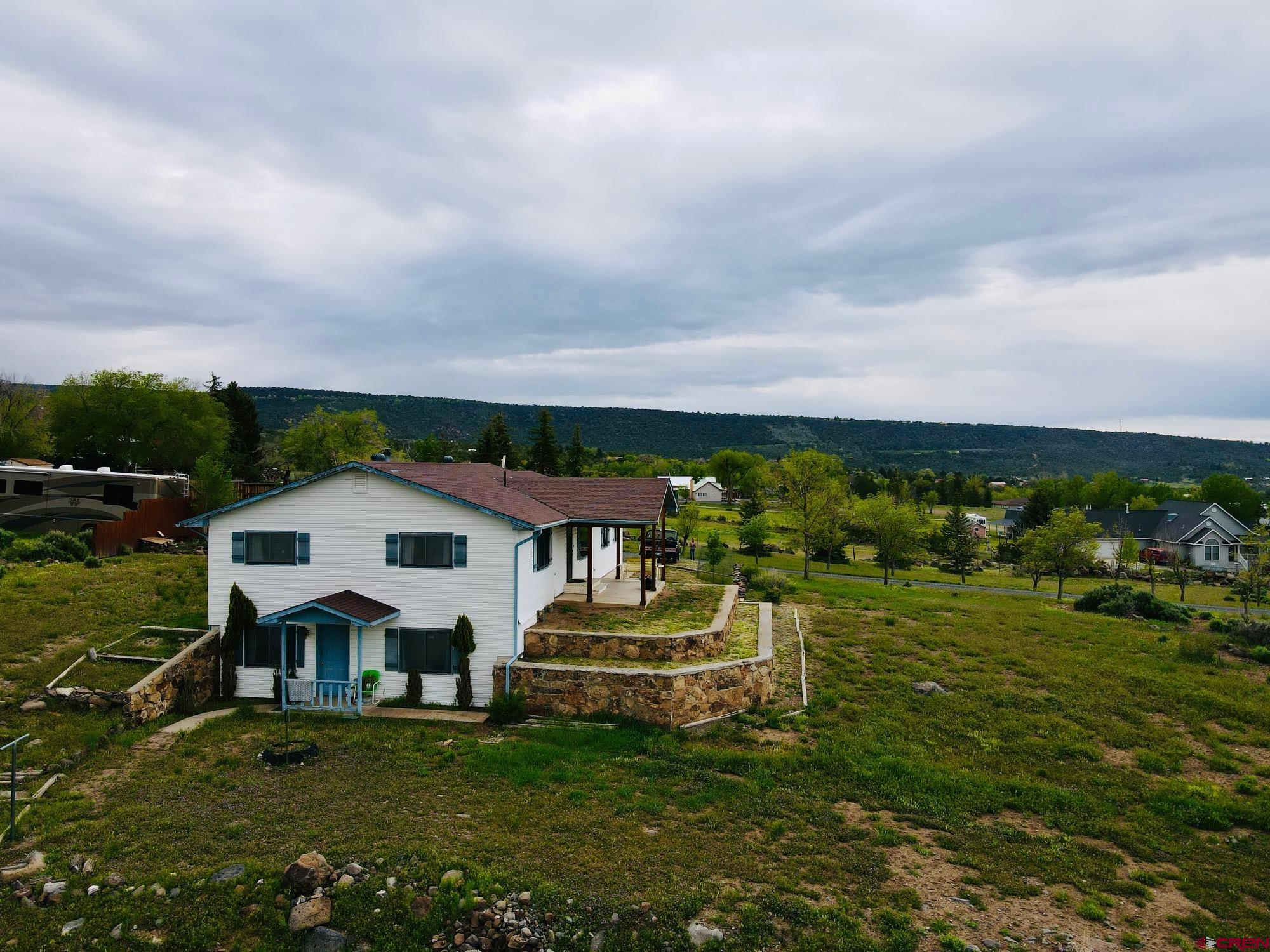 18574 Eastridge Road Cedaredge, CO 81413 - Photo 5 of 20 a aerial view of a house with a garden