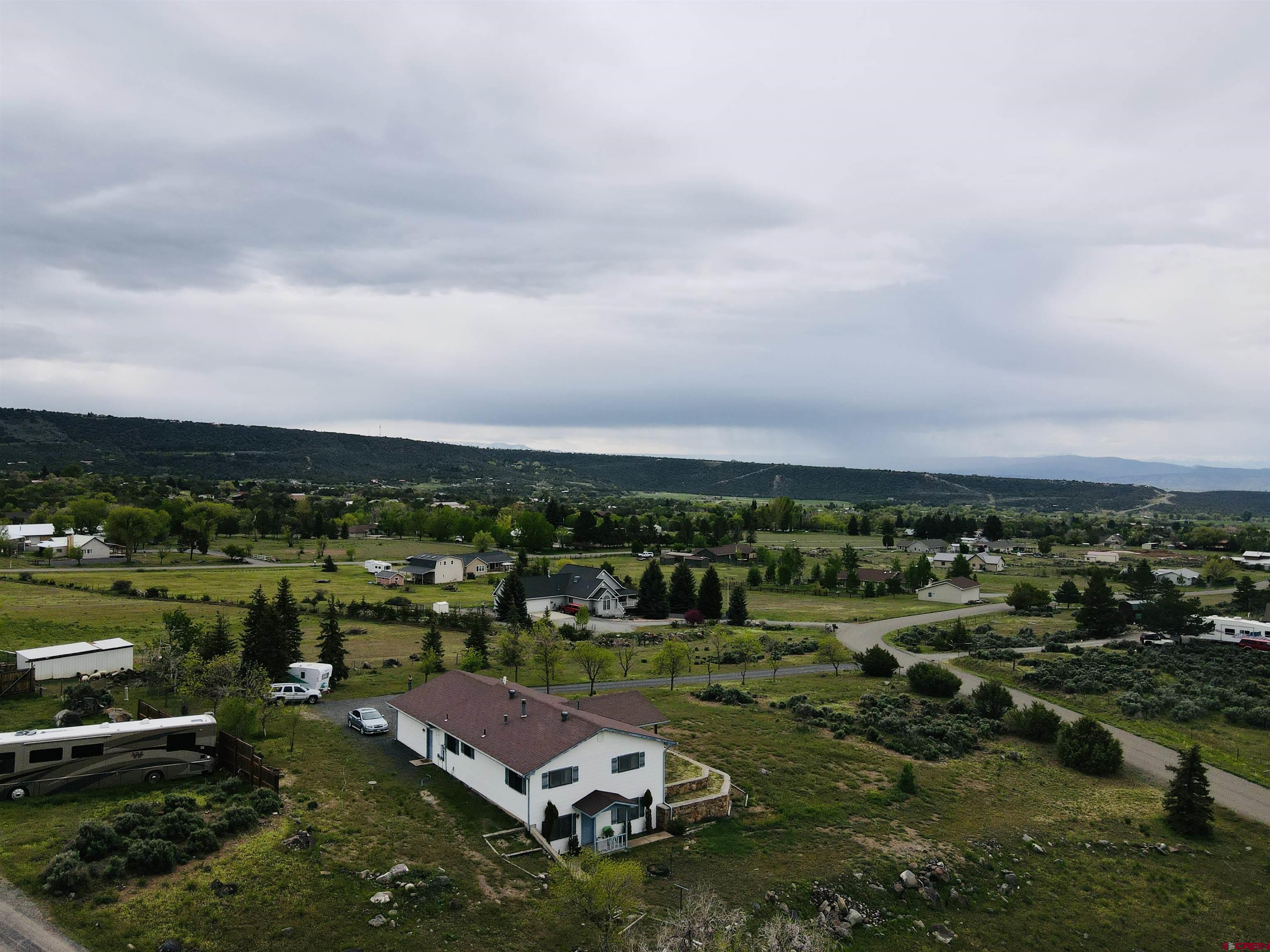 18574 Eastridge Road Cedaredge, CO 81413 - Photo 7 of 20 an aerial view of a house with a yard