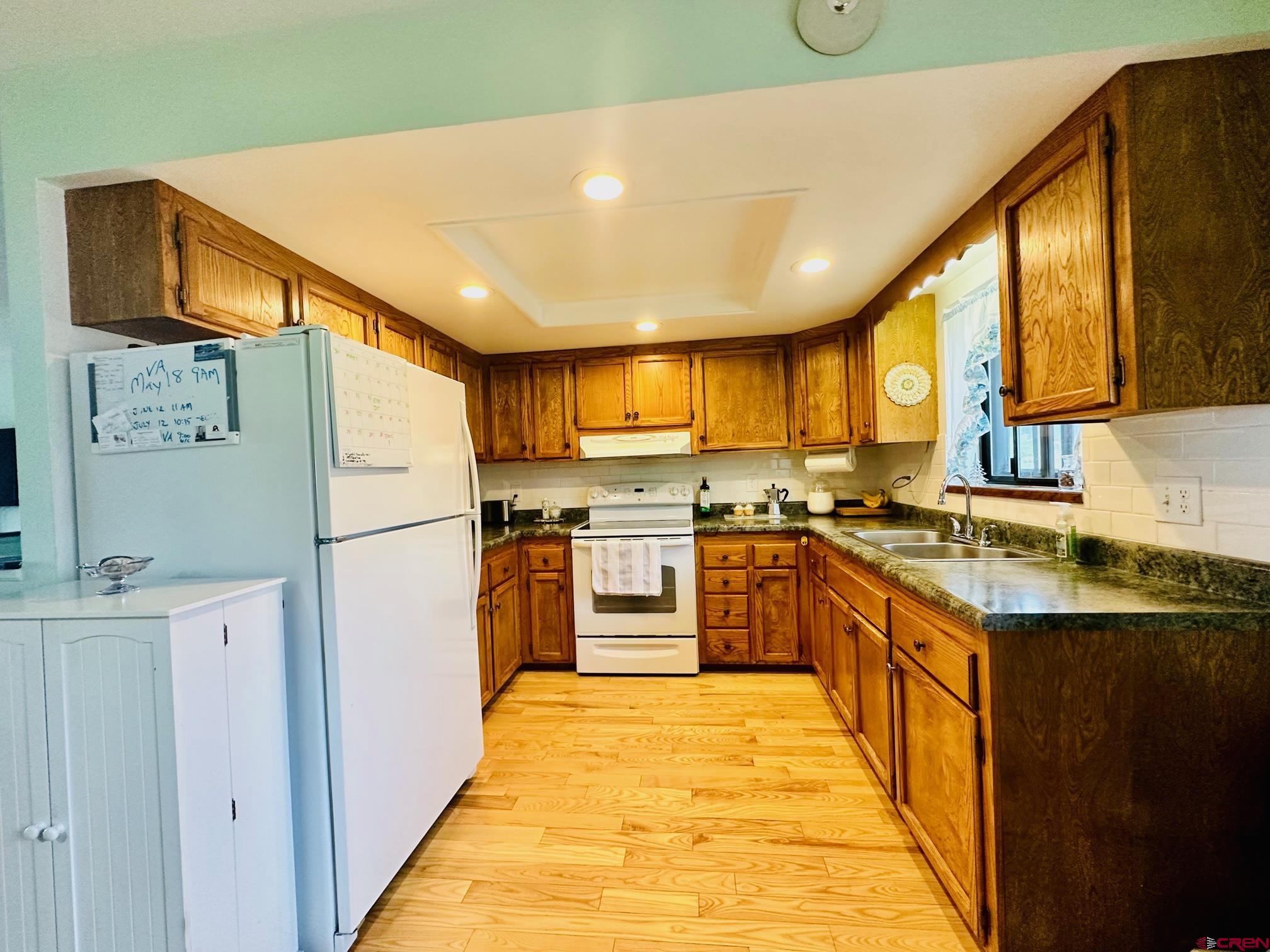 18574 Eastridge Road Cedaredge, CO 81413 - Photo 10 of 20 a kitchen with stainless steel appliances granite countertop a refrigerator and a stove top oven