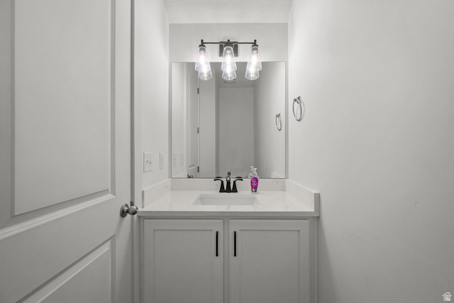 1693 North Center Point Lane Salem, UT 84653 - Photo 20 of 26 Single vanity featuring a white countertop, undermount sink, and black faucet