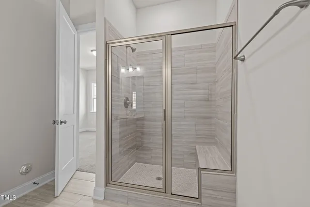 a bathroom with a glass shower door