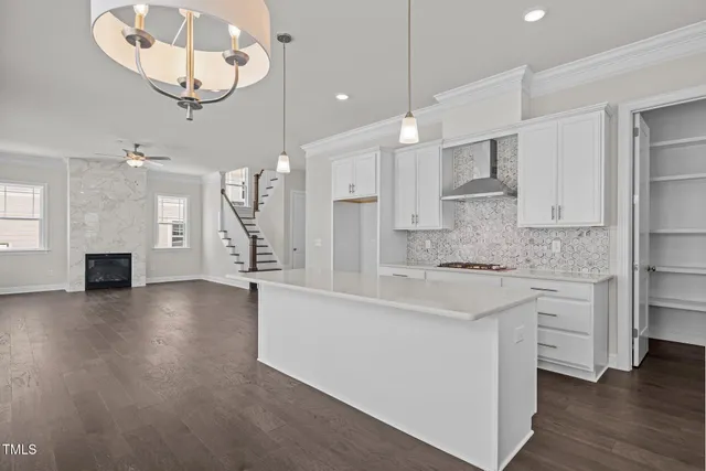 a large kitchen with cabinets and wooden floor