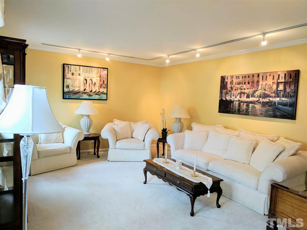1004 Wofford Lane Raleigh, NC 27609 - Photo 3 of 13 a living room with furniture and a wall painting